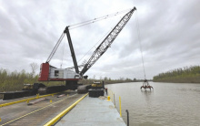 Special equipment, specifically a Link Belt LS-818 300-ton lattice boom crawler crane named “Big Juicy”, was used to complete dredging of the harbor at the Lake Providence Port. The crane is equipped with a 6CY clam shell to effectively clear large rocks. COURTESY PHOTO